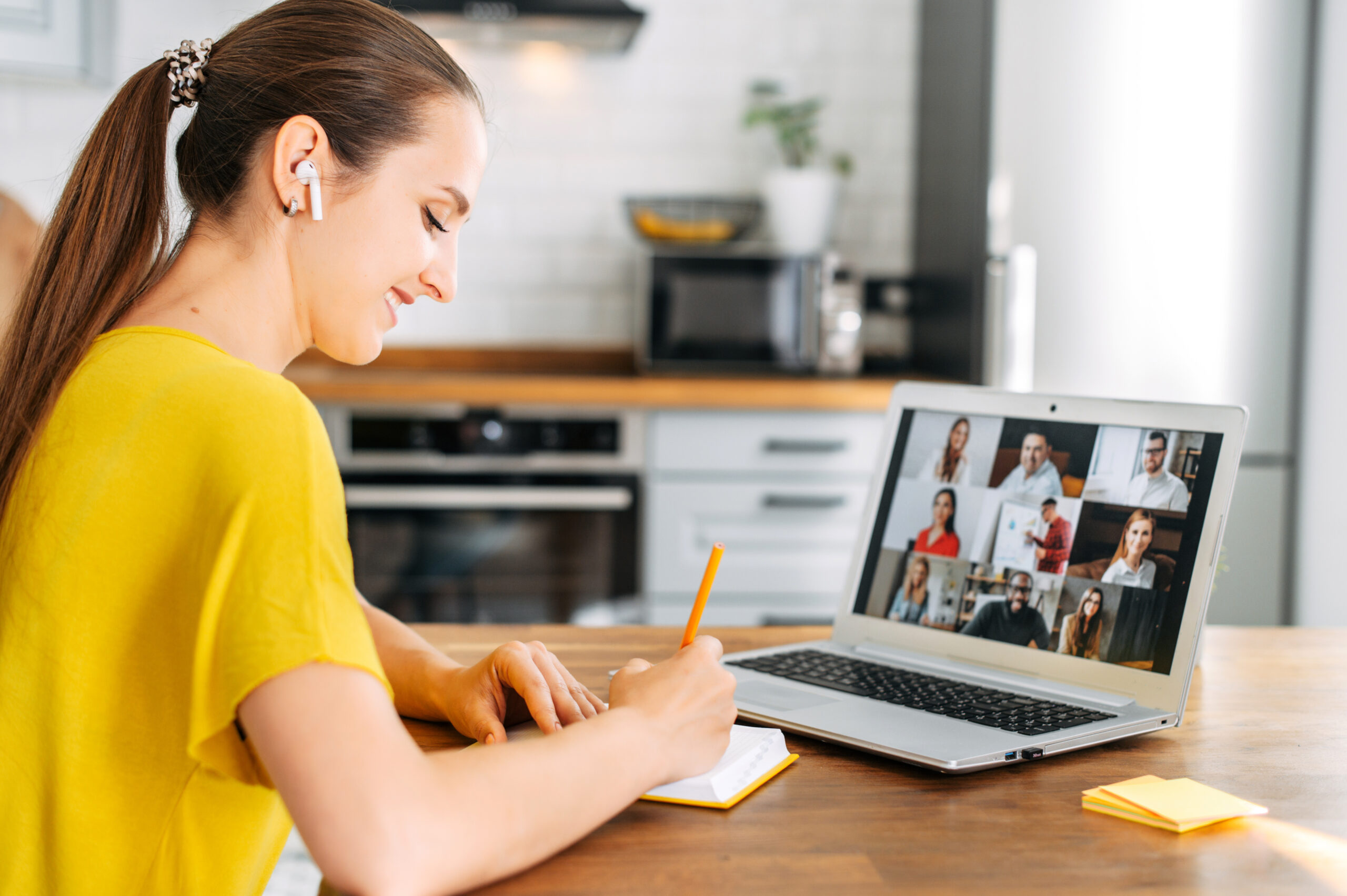 Woman uses laptop for video call indoor