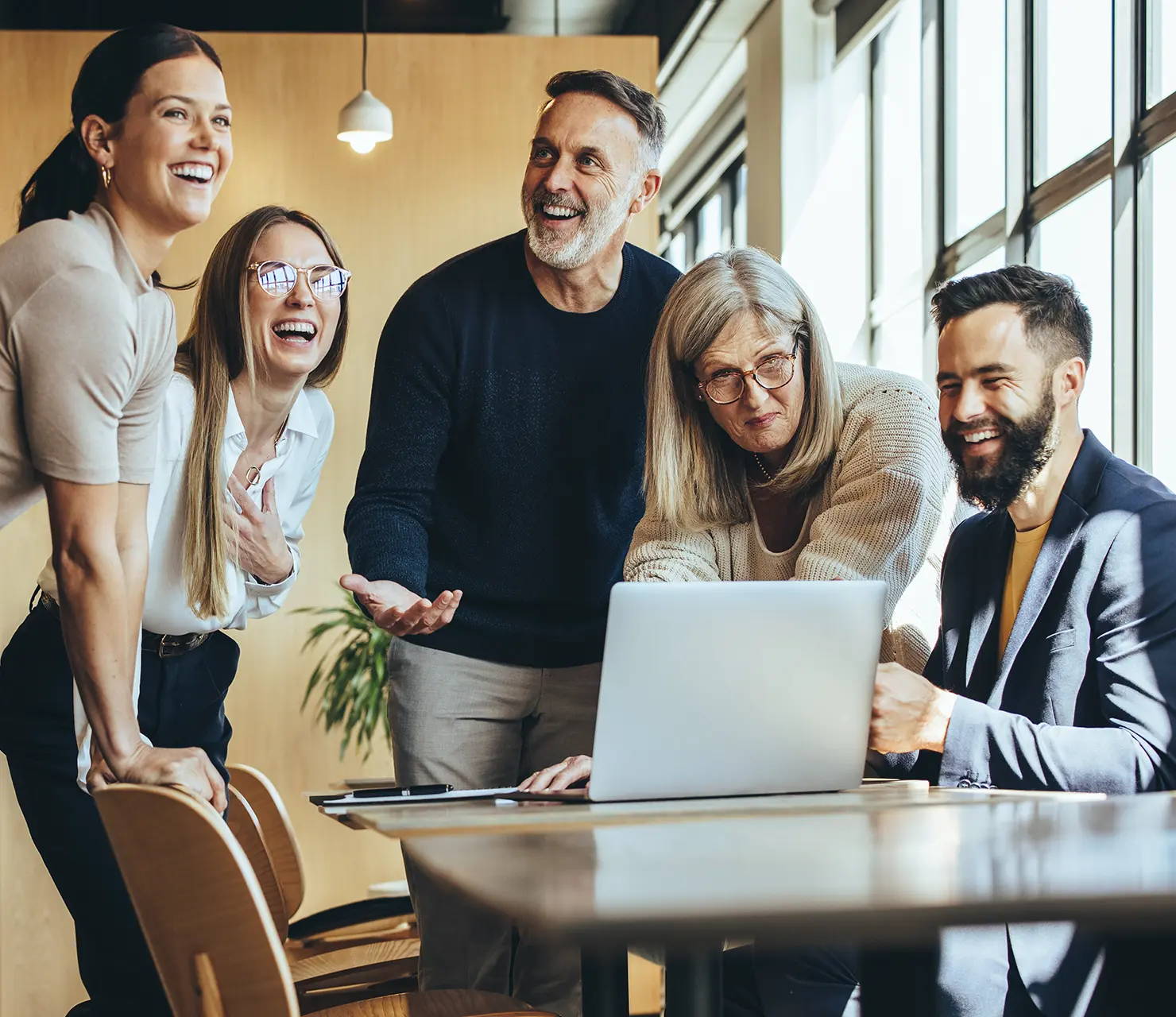 Ein lachendes team von Maklern unterschiedlichen Alters