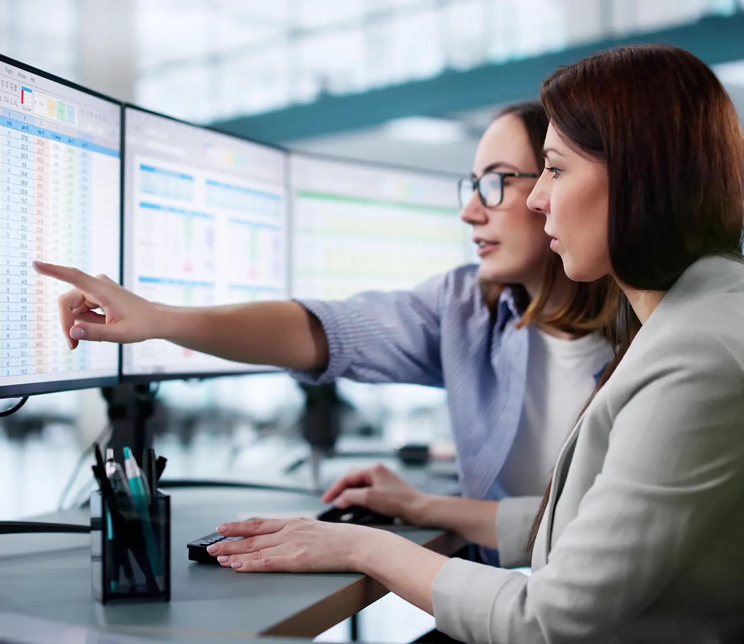 Zwei Maklerinnen erstellen vor dem PC eine Analyse