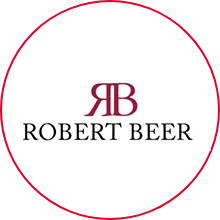Robert Beer Logo, roter Kreis mit Initialen und Namen