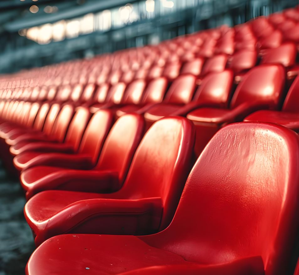 Ein leeres Stadion mit roten Sitzreihen. Die Sitze sind in perfekter Ordnung.